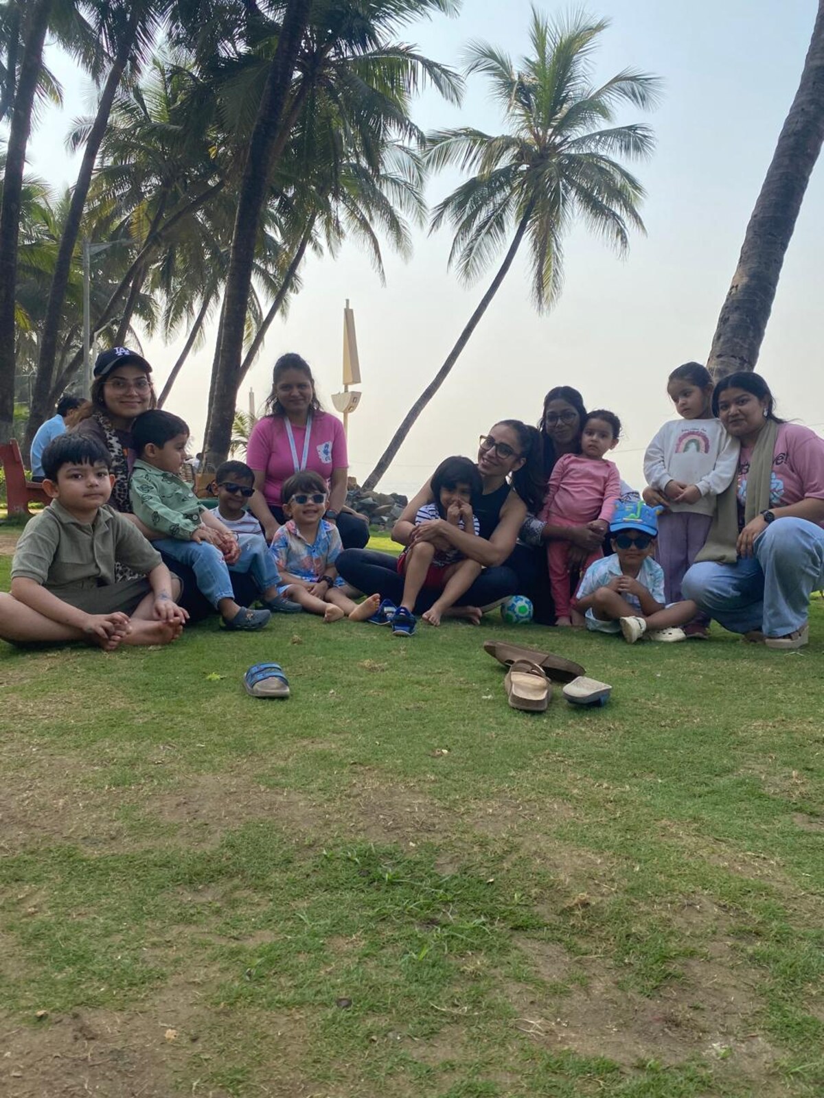 Children and educators gathered for an outdoor learning circle by the sea