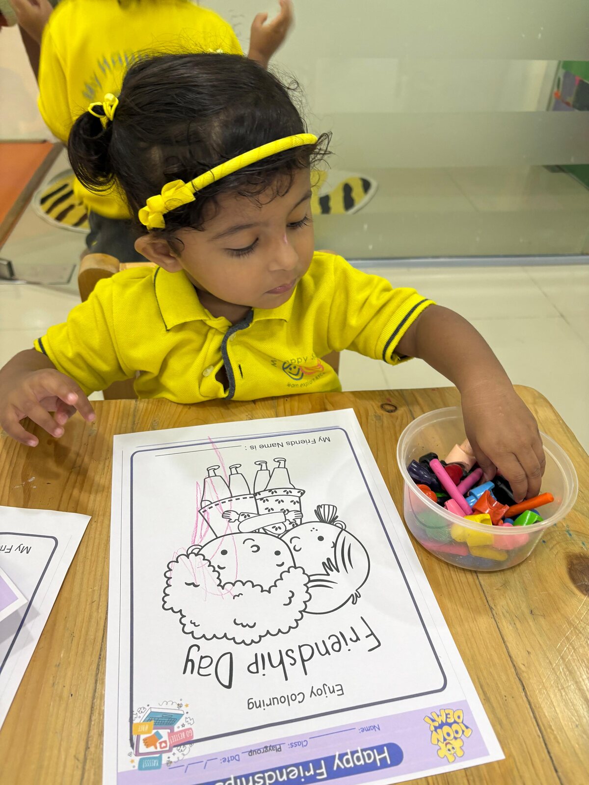 Child colouring during a creative classroom task