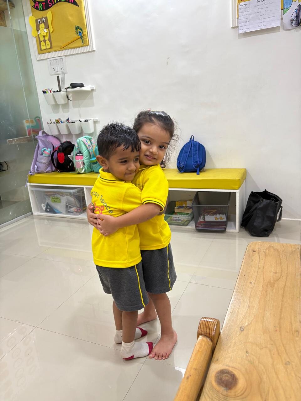 Smiling children inside the My Happy Space classroom